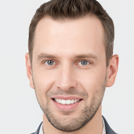 Joyful white young-adult male with short  brown hair and grey eyes