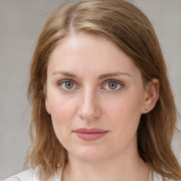 Joyful white young-adult female with medium  brown hair and blue eyes