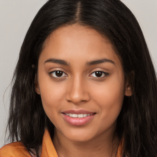 Joyful latino young-adult female with long  brown hair and brown eyes