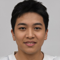 Joyful asian young-adult male with short  black hair and brown eyes