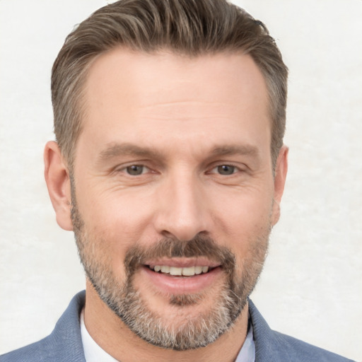 Joyful white adult male with short  brown hair and brown eyes