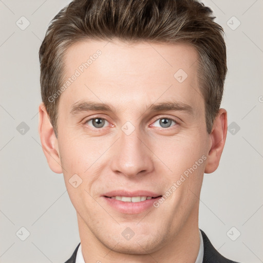 Joyful white young-adult male with short  brown hair and grey eyes