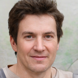 Joyful white adult male with short  brown hair and grey eyes