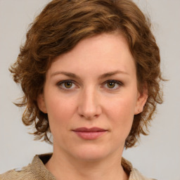 Joyful white young-adult female with medium  brown hair and green eyes