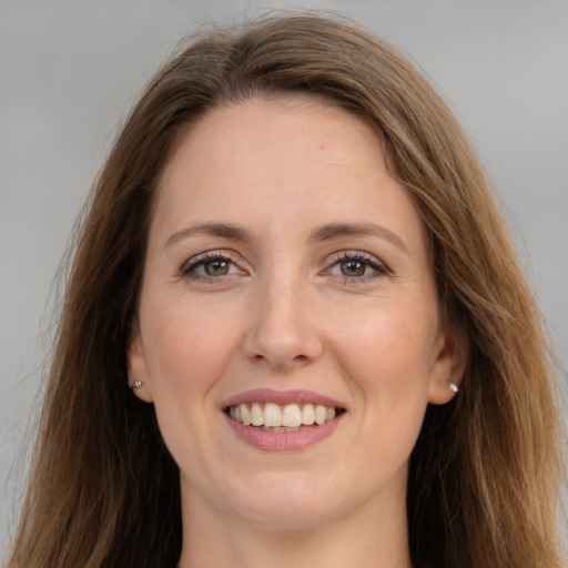 Joyful white young-adult female with long  brown hair and grey eyes