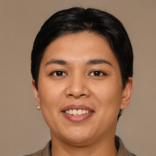 Joyful asian young-adult female with short  brown hair and brown eyes
