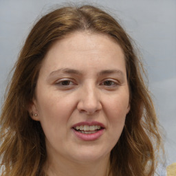 Joyful white adult female with long  brown hair and brown eyes