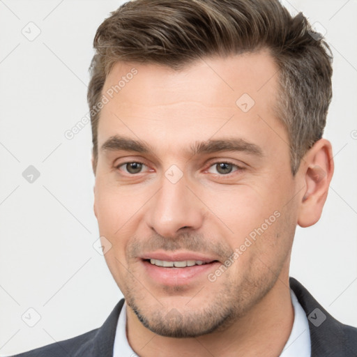 Joyful white young-adult male with short  brown hair and brown eyes