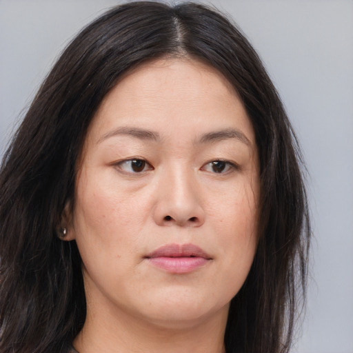 Joyful asian young-adult female with long  brown hair and brown eyes