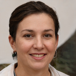 Joyful white adult female with medium  brown hair and brown eyes