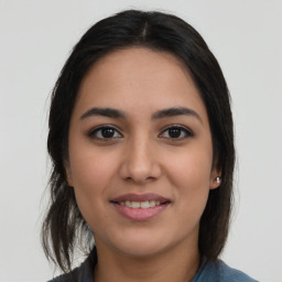 Joyful latino young-adult female with medium  brown hair and brown eyes