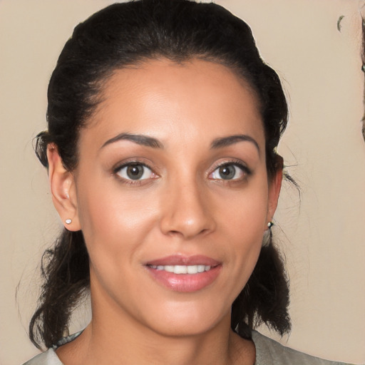 Joyful white young-adult female with medium  brown hair and brown eyes