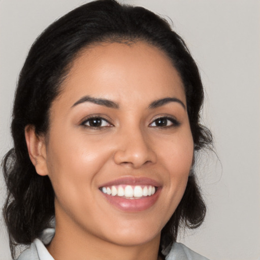 Joyful latino young-adult female with medium  brown hair and brown eyes