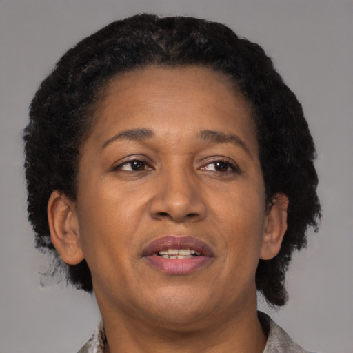 Joyful black adult female with short  brown hair and brown eyes
