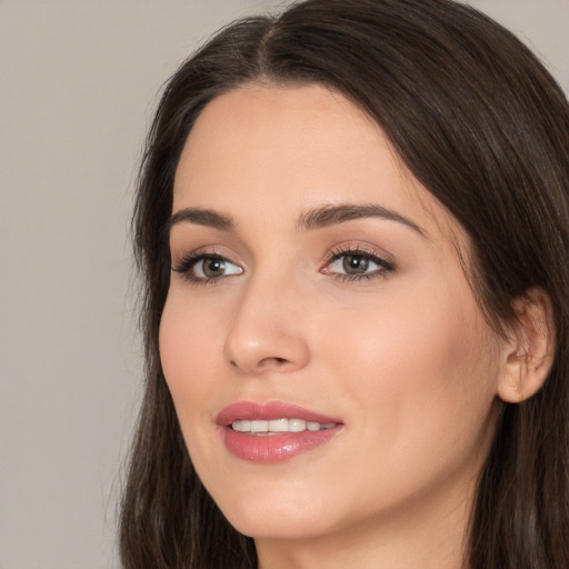 Joyful white young-adult female with long  brown hair and brown eyes