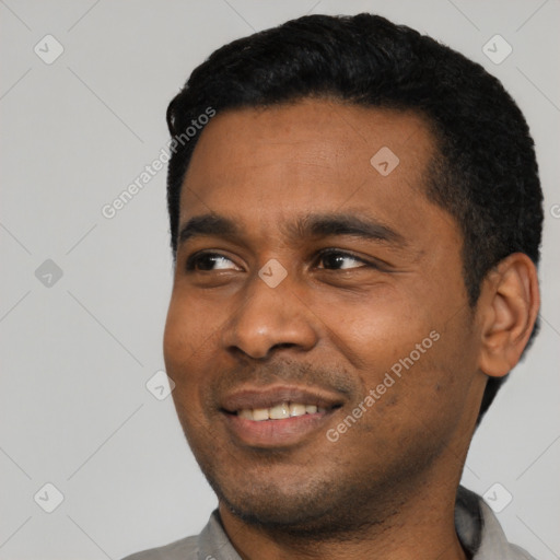 Joyful latino young-adult male with short  black hair and brown eyes