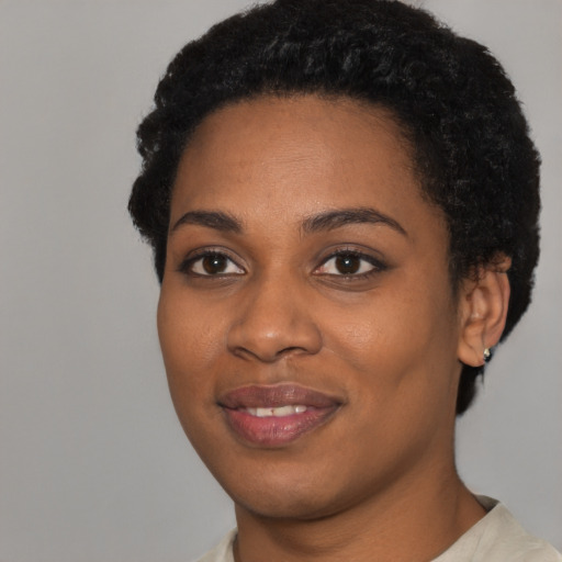 Joyful latino young-adult female with short  black hair and brown eyes