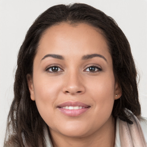 Joyful white young-adult female with long  brown hair and brown eyes