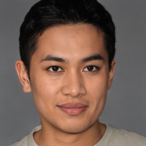 Joyful asian young-adult male with short  brown hair and brown eyes