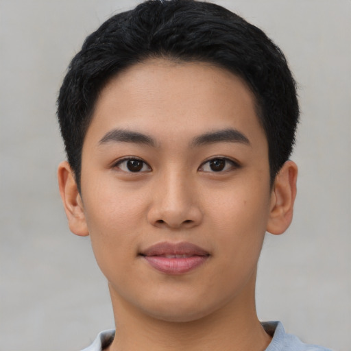 Joyful asian young-adult male with short  black hair and brown eyes