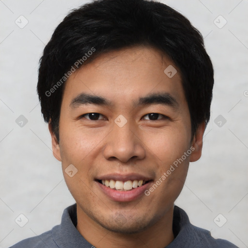 Joyful asian young-adult male with short  black hair and brown eyes