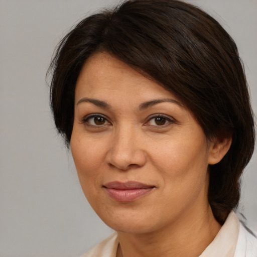 Joyful white adult female with medium  brown hair and brown eyes