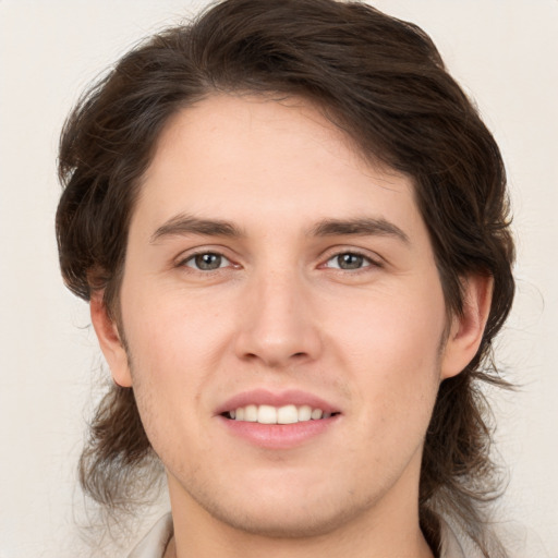 Joyful white young-adult male with medium  brown hair and brown eyes