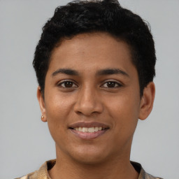 Joyful latino young-adult female with short  black hair and brown eyes
