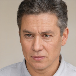 Joyful white middle-aged male with short  brown hair and brown eyes