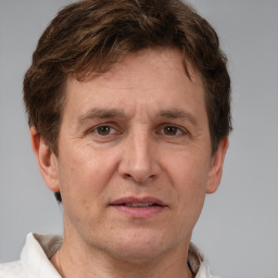 Joyful white adult male with short  brown hair and grey eyes