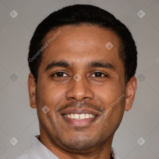 Joyful latino young-adult male with short  black hair and brown eyes