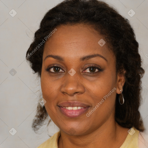 Joyful black adult female with medium  brown hair and brown eyes