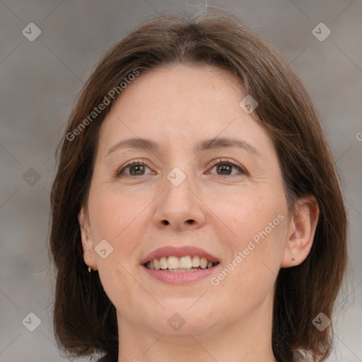 Joyful white adult female with medium  brown hair and grey eyes