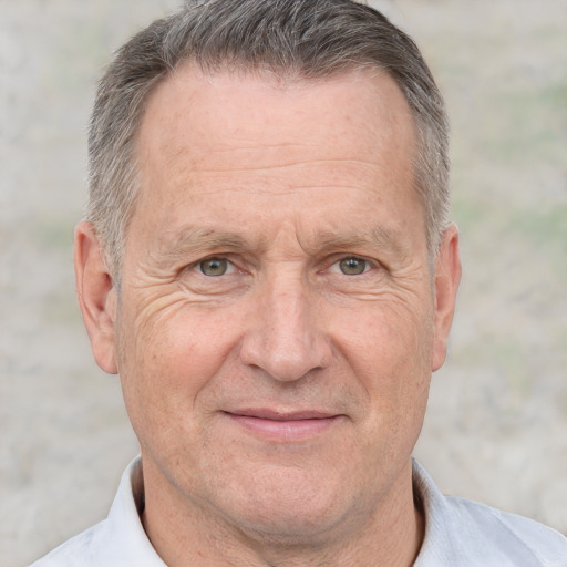 Joyful white middle-aged male with short  gray hair and brown eyes