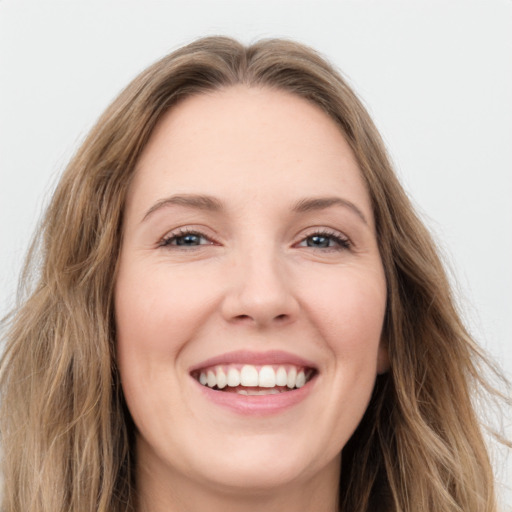 Joyful white young-adult female with long  brown hair and green eyes