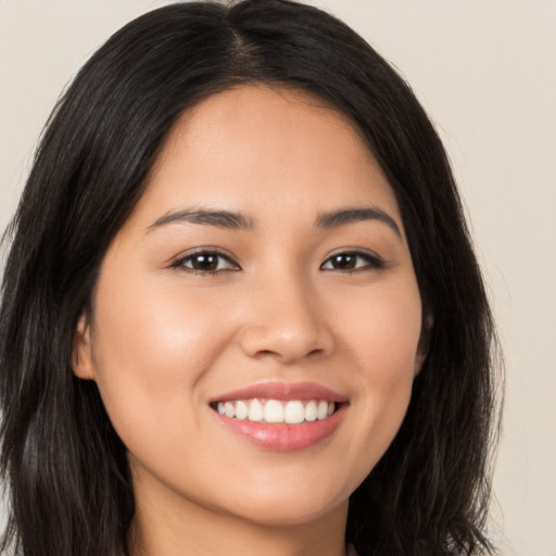 Joyful white young-adult female with long  brown hair and brown eyes