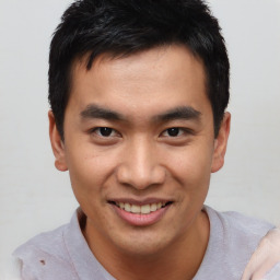 Joyful asian young-adult male with short  brown hair and brown eyes