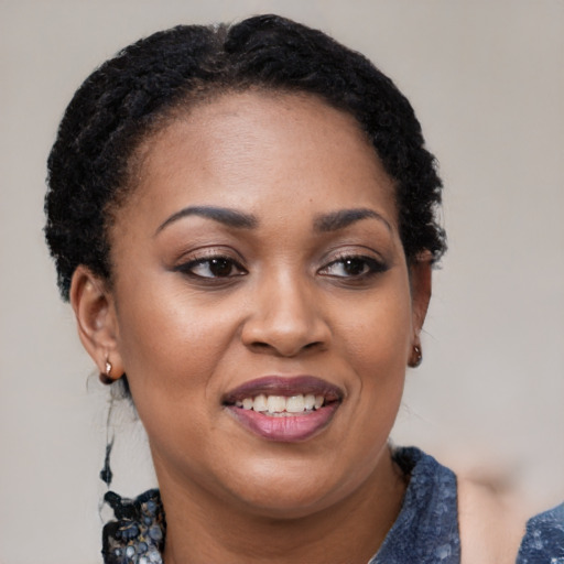 Joyful black young-adult female with medium  black hair and brown eyes