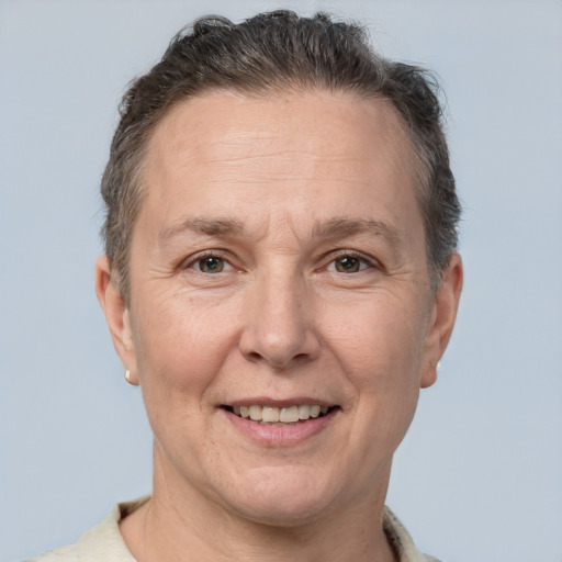 Joyful white middle-aged female with short  brown hair and brown eyes