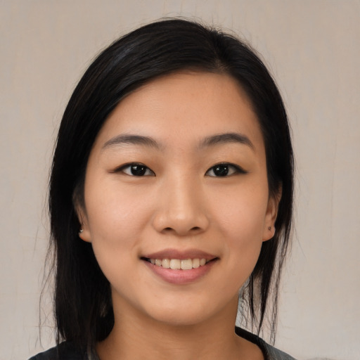 Joyful asian young-adult female with medium  black hair and brown eyes