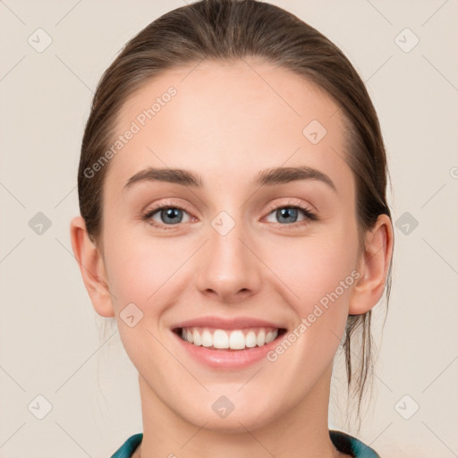 Joyful white young-adult female with medium  brown hair and blue eyes