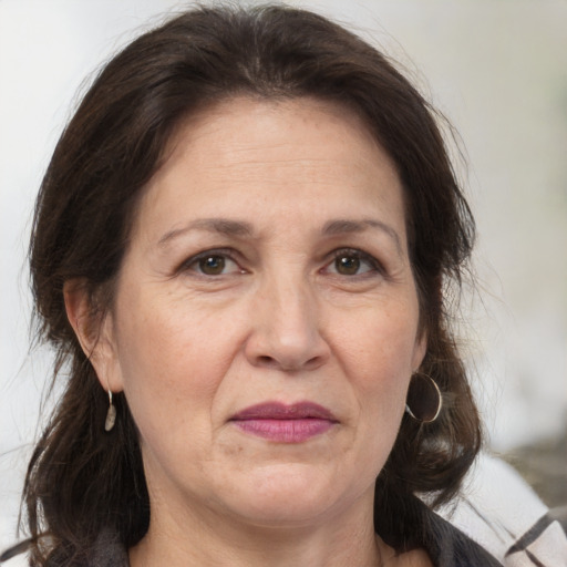 Joyful white adult female with medium  brown hair and brown eyes