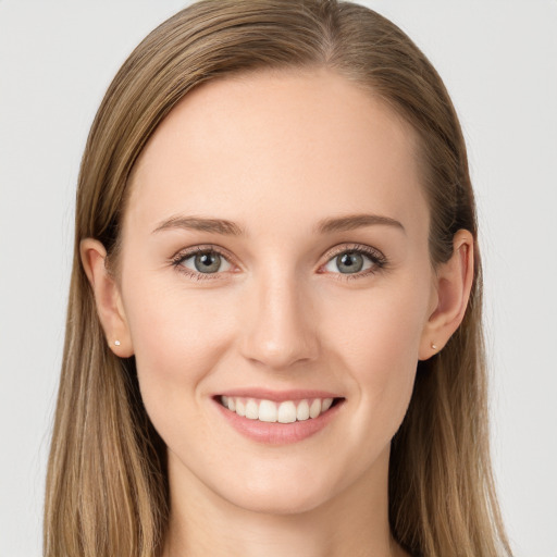 Joyful white young-adult female with long  brown hair and blue eyes