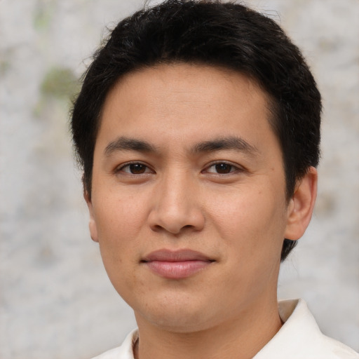 Joyful asian young-adult male with short  brown hair and brown eyes