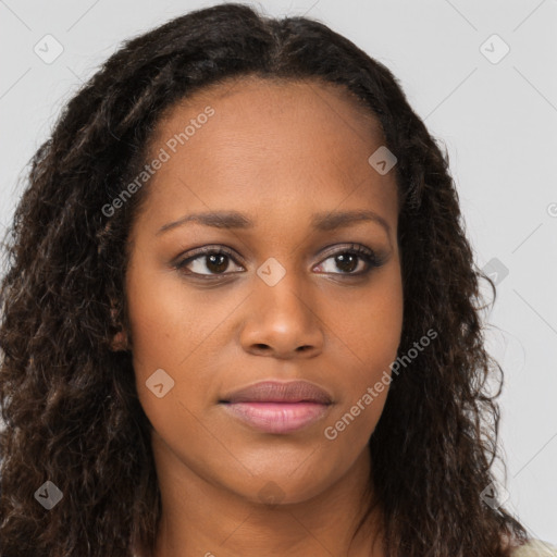 Joyful black young-adult female with long  brown hair and brown eyes