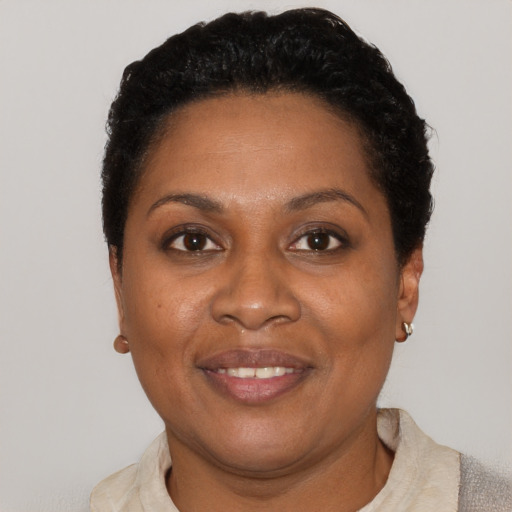 Joyful black adult female with short  brown hair and brown eyes