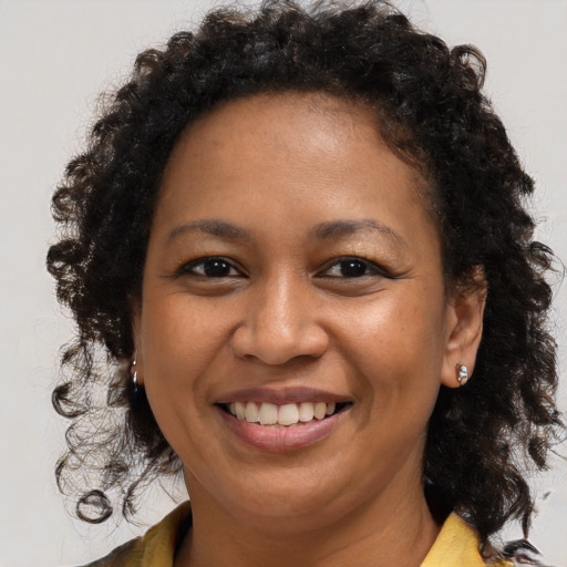 Joyful black young-adult female with medium  brown hair and brown eyes
