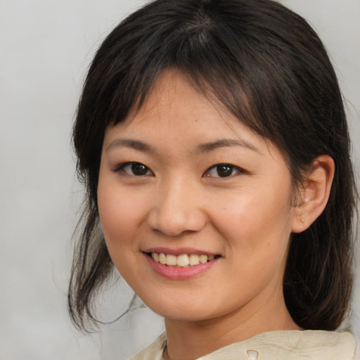 Joyful asian young-adult female with medium  brown hair and brown eyes