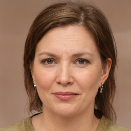 Joyful white adult female with medium  brown hair and brown eyes