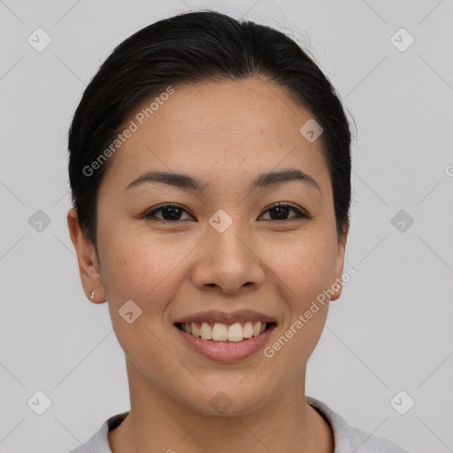 Joyful asian young-adult female with short  black hair and brown eyes